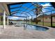 Stunning pool and spa with a fountain, screened enclosure, and lake views provide the ultimate outdoor oasis at 5383 Creekside Trl, Sarasota, FL 34243