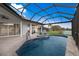 Inviting pool with fountain and screened enclosure overlooks scenic views of the water and landscaped yard at 5383 Creekside Trl, Sarasota, FL 34243