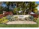 Community entrance sign with lush tropical landscaping and manicured lawn at 5383 Creekside Trl, Sarasota, FL 34243