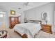 Calm bedroom with neutral walls, tile floors, and classic wooden furniture at 5889 Canal Dr # I4, Bradenton, FL 34207