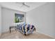 Well-lit bedroom featuring neutral walls, tile floors and a view of the outdoors at 5889 Canal Dr # I4, Bradenton, FL 34207