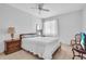 Bright bedroom with tile floors, ceiling fan, and large window with natural light at 5889 Canal Dr # I4, Bradenton, FL 34207