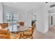 Charming dining area with a glass-top table and wicker chairs near the kitchen at 5889 Canal Dr # I4, Bradenton, FL 34207