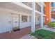 Condo entrance featuring a white door, white siding, and a small outdoor area at 5889 Canal Dr # I4, Bradenton, FL 34207