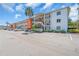 Multi-story condo building with ample parking and well-maintained landscaping at 5889 Canal Dr # I4, Bradenton, FL 34207