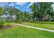 Beautifully landscaped grounds featuring lush green grass, mature trees, and paved walkways at 5889 Canal Dr # I4, Bradenton, FL 34207