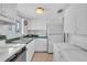 Bright kitchen featuring white cabinetry, standard appliances, and tiled flooring at 5889 Canal Dr # I4, Bradenton, FL 34207