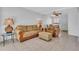 Cozy living room with neutral-toned furniture, tile flooring, and a ceiling fan at 5889 Canal Dr # I4, Bradenton, FL 34207