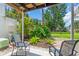 Relaxing patio with comfortable seating amidst tropical landscaping and mature trees at 5889 Canal Dr # I4, Bradenton, FL 34207