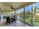 Enclosed lanai featuring views of a pond, seating and ceiling fan for comfortable outdoor living at 6101 34Th W St # 17C, Bradenton, FL 34210