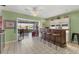 Charming bar area with seating, custom shelving, and views of the waterway at 6420 13Th Avenue W Dr, Bradenton, FL 34209