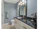 Modern bathroom with sleek vanity, marble countertop, and walk-in shower at 6420 13Th Avenue W Dr, Bradenton, FL 34209