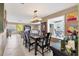 Open-concept dining room with stylish furnishings, chandelier, and waterway views at 6420 13Th Avenue W Dr, Bradenton, FL 34209