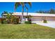 Charming home with lush green lawn, mature landscaping, and a two-car garage at 6420 13Th Avenue W Dr, Bradenton, FL 34209
