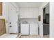 Functional laundry room with washer, dryer, and storage cabinets at 6420 13Th Avenue W Dr, Bradenton, FL 34209