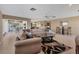 Open concept living room featuring a large sofa and open access to the dining area at 6420 13Th Avenue W Dr, Bradenton, FL 34209