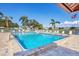 Inviting community swimming pool surrounded by comfortable lounge chairs and lush tropical landscaping at 6420 13Th Avenue W Dr, Bradenton, FL 34209