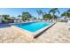Beautiful swimming pool with pristine water surrounded by a spacious deck and comfortable lounge chairs at 6420 13Th Avenue W Dr, Bradenton, FL 34209