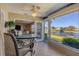 Bright sunroom features tile flooring, ceiling fan, and beautiful lake views at 6420 13Th Avenue W Dr, Bradenton, FL 34209