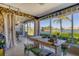 Bright sunroom with water views, table, and comfortable seating area at 6420 13Th Avenue W Dr, Bradenton, FL 34209