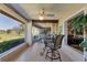 Inviting sunroom featuring tiled floors, bright windows, and views of lush landscaping at 6420 13Th Avenue W Dr, Bradenton, FL 34209