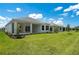 Lush backyard with a covered patio, showcasing the home's exterior and landscaping at 8024 Moonbeam Ave, Sarasota, FL 34241