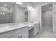 A dual sink vanity and entrance to a walk-in closet in the bathroom at 8024 Moonbeam Ave, Sarasota, FL 34241