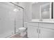 Modern bathroom with a glass-enclosed shower, white vanity, and sleek fixtures at 8024 Moonbeam Ave, Sarasota, FL 34241