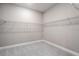 Walk-in closet is fitted with bright lighting, neutral walls and wire shelving at 8024 Moonbeam Ave, Sarasota, FL 34241