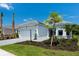 New construction features a white exterior, manicured lawn, and paver driveway, offering a clean, modern aesthetic at 8024 Moonbeam Ave, Sarasota, FL 34241
