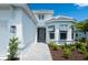 Inviting front entrance with a paved walkway, stylish exterior lighting, and freshly planted landscaping at 8024 Moonbeam Ave, Sarasota, FL 34241