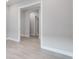 Hallway view highlighting the bright, neutral walls and trim, and tile floors at 8024 Moonbeam Ave, Sarasota, FL 34241