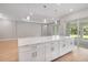 Open-concept design featuring a large kitchen island with elegant countertops and ample seating space at 8024 Moonbeam Ave, Sarasota, FL 34241