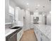 Contemporary kitchen with stainless steel appliances, a large island, and sleek cabinetry at 8024 Moonbeam Ave, Sarasota, FL 34241