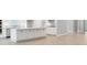 Modern kitchen features a large island with white cabinetry, stainless steel appliances, and neutral countertops at 8024 Moonbeam Ave, Sarasota, FL 34241