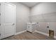 Functional laundry room with a sink, shelving, and wood-look tile flooring at 8024 Moonbeam Ave, Sarasota, FL 34241