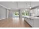 Expansive living area with wood floors, recessed lighting, and seamless flow to kitchen and outdoor spaces at 8024 Moonbeam Ave, Sarasota, FL 34241