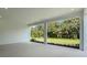 Covered patio offering a serene view of lush landscaping and green space at 8024 Moonbeam Ave, Sarasota, FL 34241