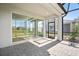 Covered patio area with stone pavers and views of the backyard and adjacent home at 8109 Moonbeam Ave, Sarasota, FL 34241