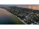 An aerial view highlighting a coastal neighborhood's homes, beaches, and ocean views at 915 N Shore Dr, Anna Maria, FL 34216