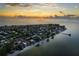 Beautiful aerial view of coastal community with stunning ocean, beach, and sunset views at 915 N Shore Dr, Anna Maria, FL 34216