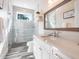 Modern bathroom featuring a glass shower, sleek fixtures, and elegant countertops at 915 N Shore Dr, Anna Maria, FL 34216