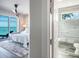 Relaxing main bedroom with ensuite bath featuring a large balcony and ocean views at 915 N Shore Dr, Anna Maria, FL 34216