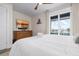Spacious bedroom with a dresser, TV, and balcony access at 915 N Shore Dr, Anna Maria, FL 34216