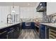 Modern kitchen with navy lower cabinets, white upper cabinets, and stainless steel appliances at 915 N Shore Dr, Anna Maria, FL 34216