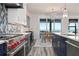 Modern kitchen features sleek stainless steel appliances, custom cabinets, and a view of the dining area and ocean at 915 N Shore Dr, Anna Maria, FL 34216