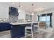 Open kitchen with a large island, bar seating, and stainless steel appliances offers an inviting space to cook and entertain at 915 N Shore Dr, Anna Maria, FL 34216