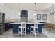 Kitchen with a center island, pendant lights, and stainless steel appliances in an open layout at 915 N Shore Dr, Anna Maria, FL 34216