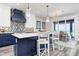 Open kitchen with a large island, bar seating, and stainless steel appliances offers an inviting space to cook and entertain at 915 N Shore Dr, Anna Maria, FL 34216
