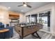 Inviting living room features a foosball table, comfortable seating, and sliding doors with stunning outdoor views at 915 N Shore Dr, Anna Maria, FL 34216